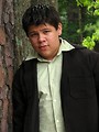 Free Stock Photo: A teen latino boy posing outdoors by a tree