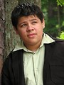 Free Stock Photo: A teen latino boy posing outdoors by a tree
