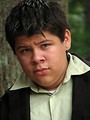 Free Stock Photo: A teen latino boy posing outdoors by a tree