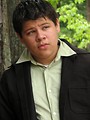 Free Stock Photo: A teen latino boy posing outdoors by a tree