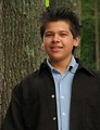 Free Stock Photo: A young latino teen boy posing outdoors by a tree