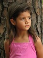 Free Stock Photo: A young latina girl posing outdoors by a tree