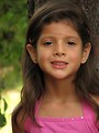 Free Stock Photo: A young latina girl posing outdoors by a tree