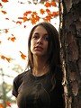 Free Stock Photo: A teenage girl leaning on a tree
