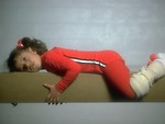 Free Stock Photo: A young girl resting on a balance beam