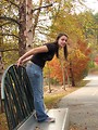 Free Stock Photo: A teenage girl playing on a bench