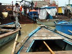 Free Stock Photo: Indian boy tying up a boat