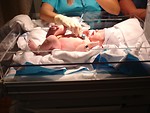 Free Stock Photo: A doctor listening to the heart of a newborn in a hospital