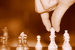 Free Stock Photo: Close-up of a hand about to move a chess piece
