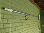 Free Stock Photo: A pool skimmer hanging on a wall