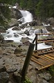 Free Stock Photo: A stream by a bridge and rocks with a small waterfall