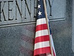 Free Stock Photo: US flag leaning on a tombstone