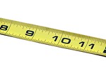 Free Stock Photo: A yellow measuring tape isolated on a white background