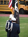 Free Stock Photo: Young soldiers carrying a US flag on a football field