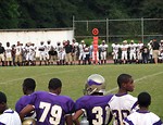 Free Stock Photo: High school football players on the sidelines of a football field