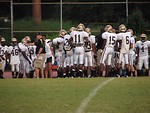 Free Stock Photo: High school football players huddled on a football field