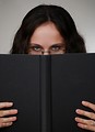 Free Stock Photo: A beautiful business woman looking over a book