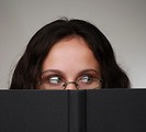 Free Stock Photo: A beautiful business woman looking over a book