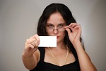 Free Stock Photo: A beautiful business woman holding a blank business card.