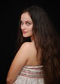 Free Stock Photo: A beautiful young woman posing before a black background