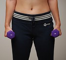 Free Stock Photo: A beautiful young woman exercising with weights