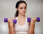 Free Stock Photo: A beautiful young woman exercising with weights