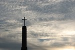Free Stock Photo: A cross before a cloudy sunset sky