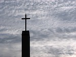 Free Stock Photo: A cross before a cloudy sunset sky