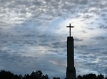 Free Stock Photo: A cross before a cloudy sunset sky