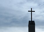 Free Stock Photo: A cross before a cloudy sunset sky