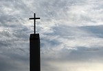 Free Stock Photo: A cross before a cloudy sunset sky