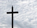 Free Stock Photo: A cross before a cloudy sunset sky