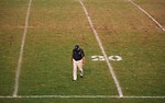 Free Stock Photo: A football coach walking on an empty football field