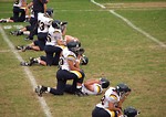 Free Stock Photo: A high school football team warming up before a game