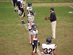 Free Stock Photo: A high school football team lined up before a game with their coach