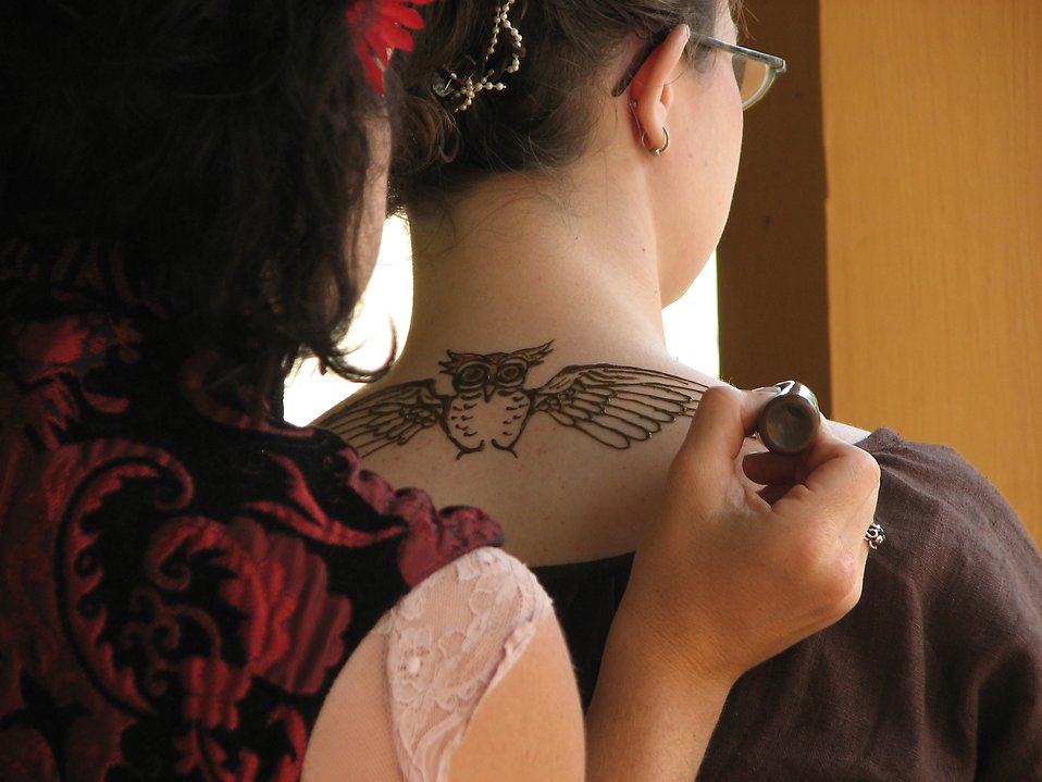 Free Stock Photo: A girl getting a temporary tattoo of an owl on her neck at 