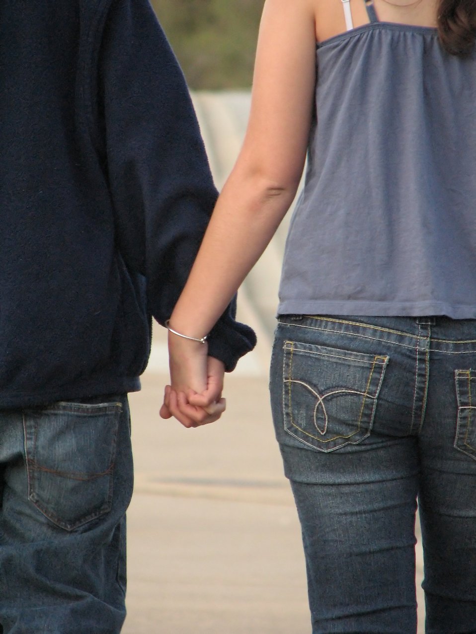 Close-up of a teen boy and girl holding hands. : Free Stock Photos